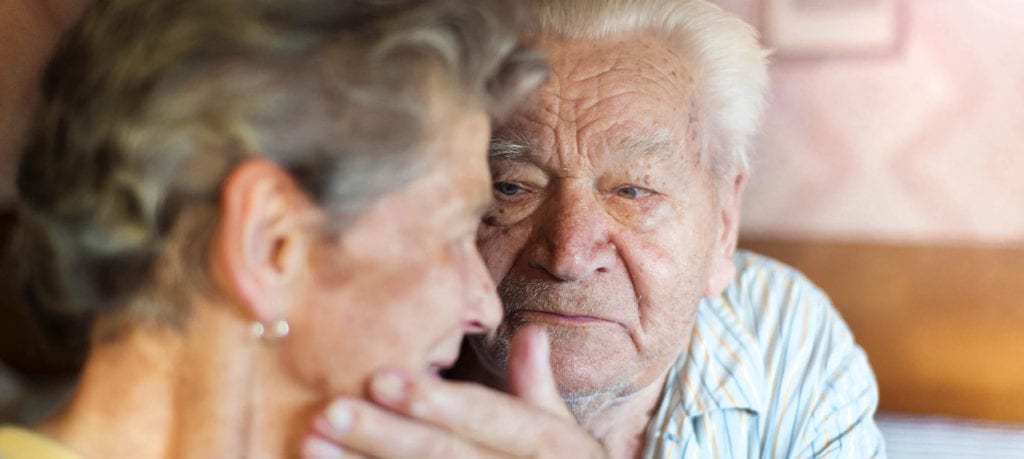 Elderly couple looking at each other