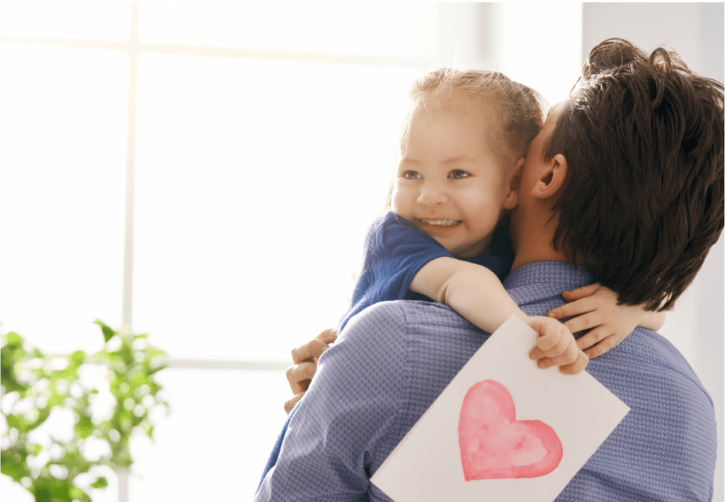 Father hugging smiling daughter