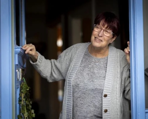 Smiling woman at doorway